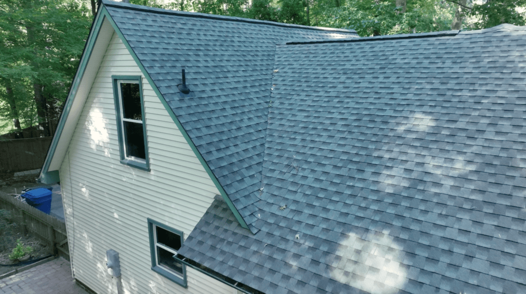 Two-story house with yellow siding and a grey asphalt shingle roof.